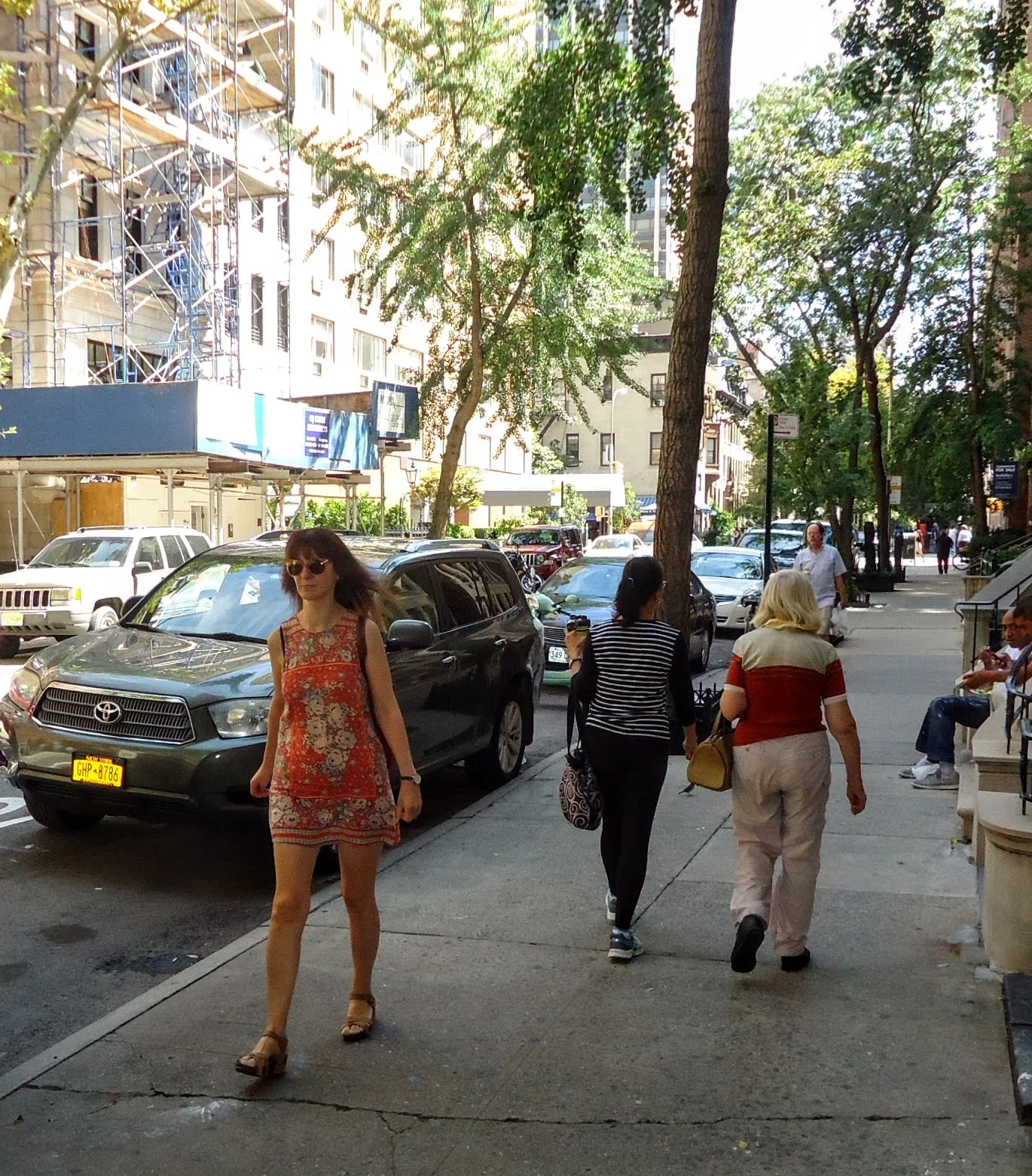 Pedestrians walking along an East Side Manhattan sidewalk